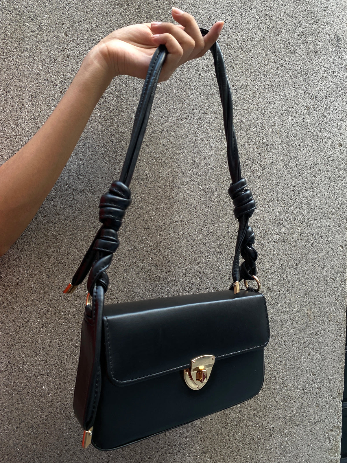 Black structured knot bag with knotted strap by Charmé